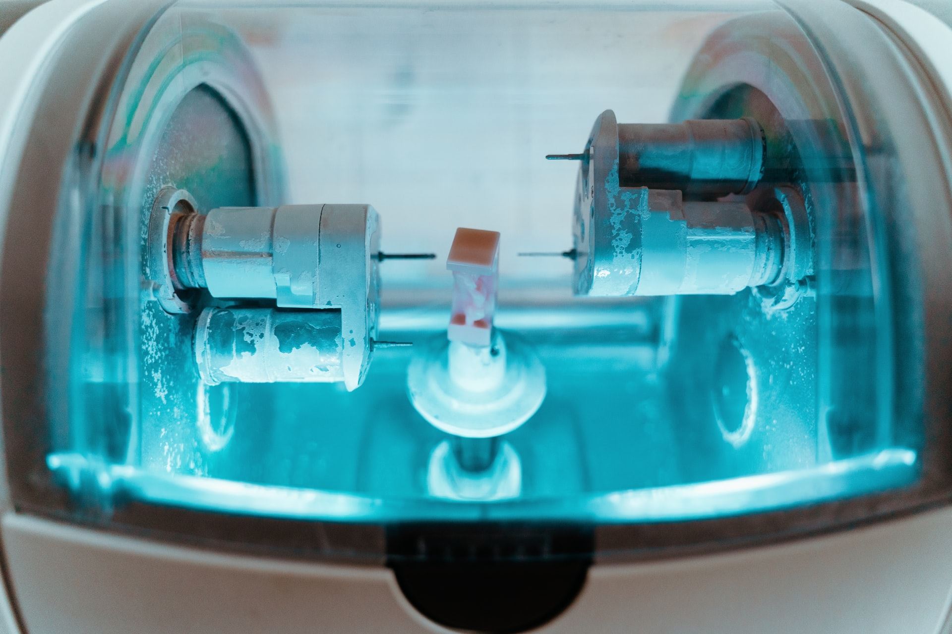 A ceramic crown being milled inside a CEREC milling unit