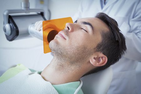 A patient resting comfortably under dental sedation