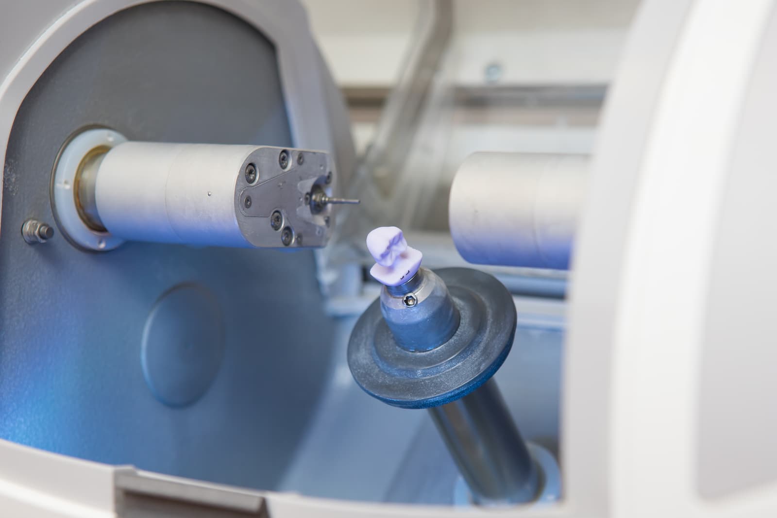 A crown being milled in the CEREC unit